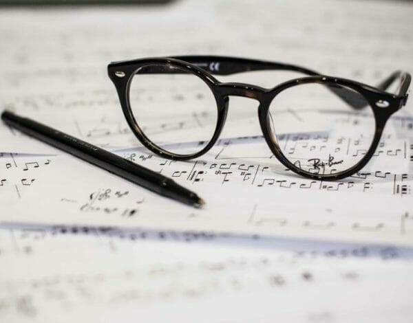 Glasses and pen on sheet music